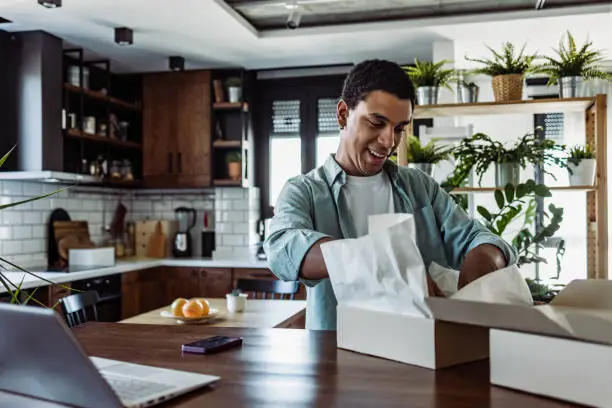 A professional unpacking in a modern furnished apartment