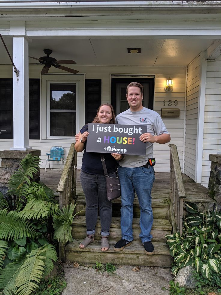 A happy couple with an agent showing them a house.